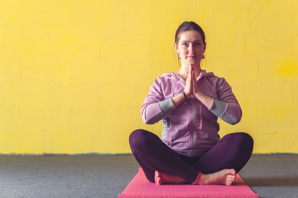 Young happy woman sitting after yoga session