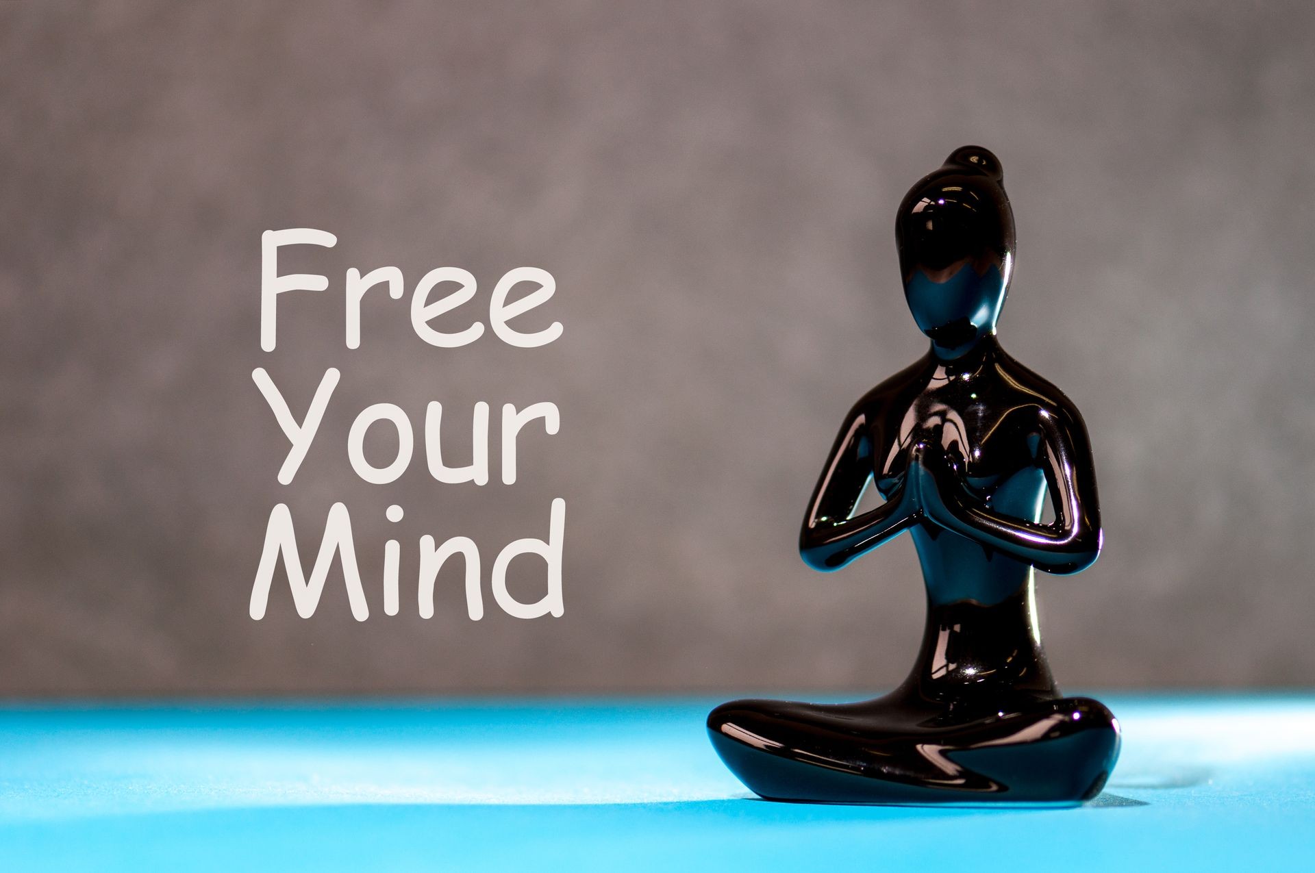 Free your mind - motivating text with white statuette of girl. Yoga and meditation concept